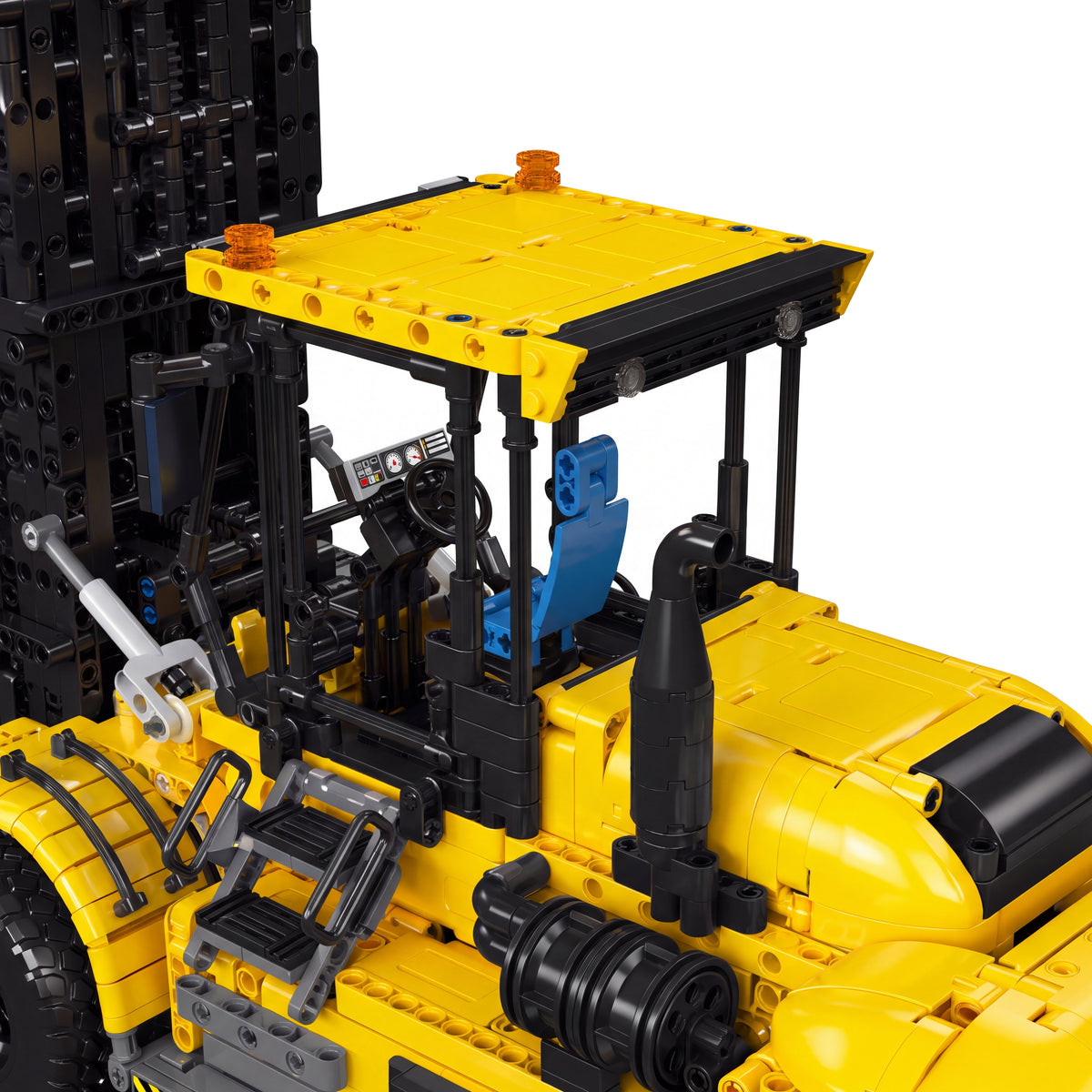 Détail de la cabine : toit jaune, siège bleu, volant et pot d'échappement